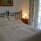Click for full size image of Holiday in Narja - Double bedroom with door to balcony